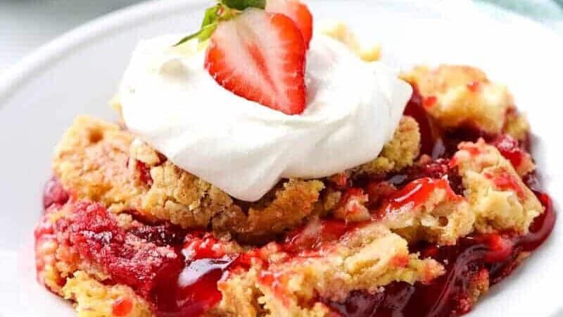 strawberry dump cake on a white plate