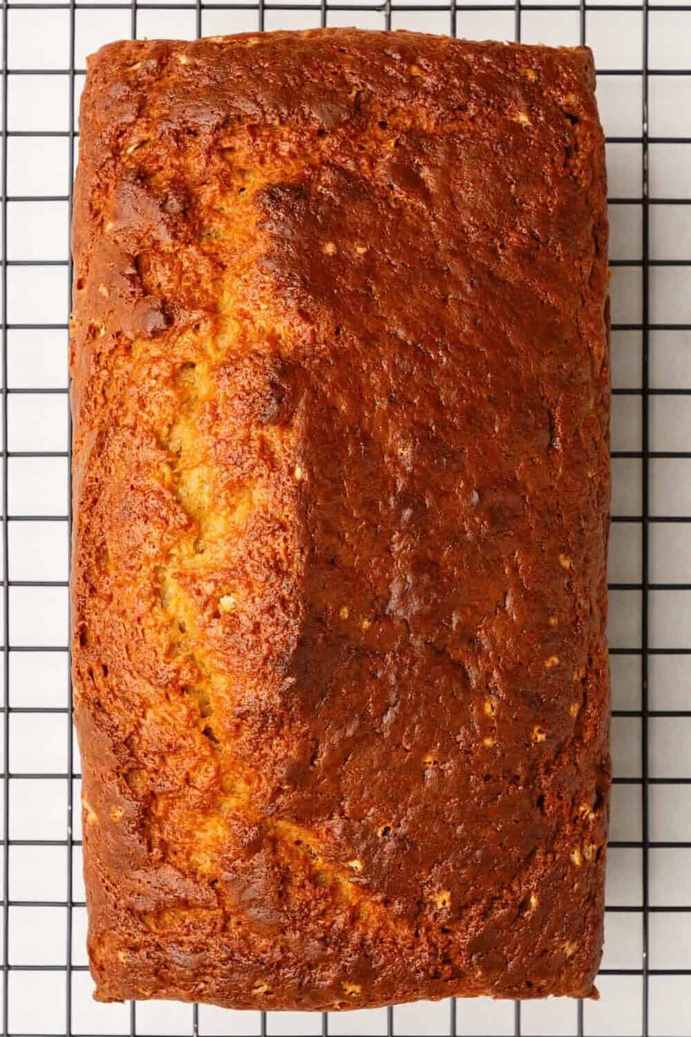 Baked 4-ingredient banana bread on a wire cooling rack.