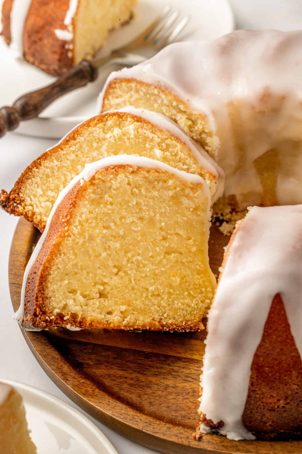 two slices of 7 up bundt cake sitting on a wooden platter.