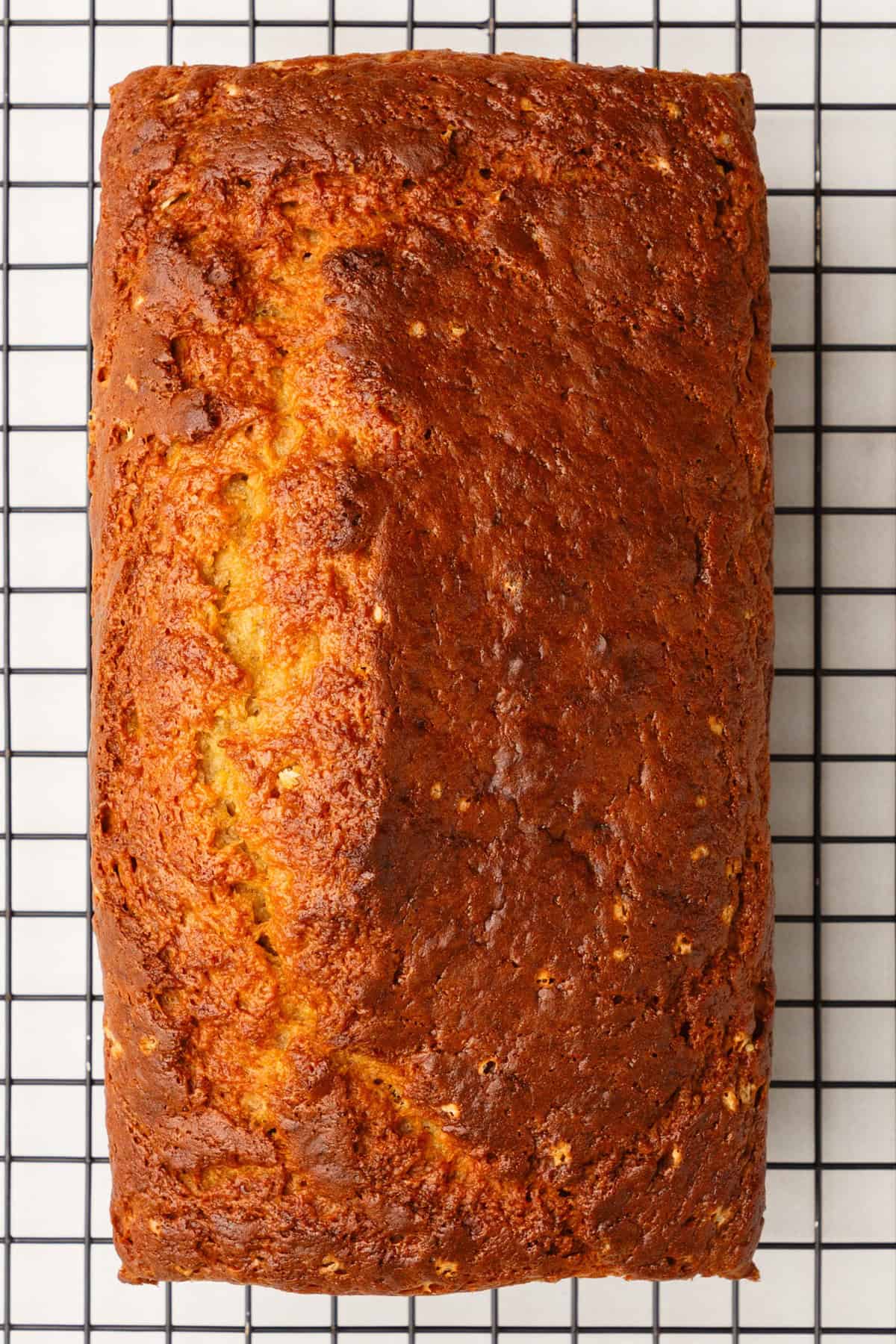 top down image of banana zucchini bread cooling on a wire rack. 