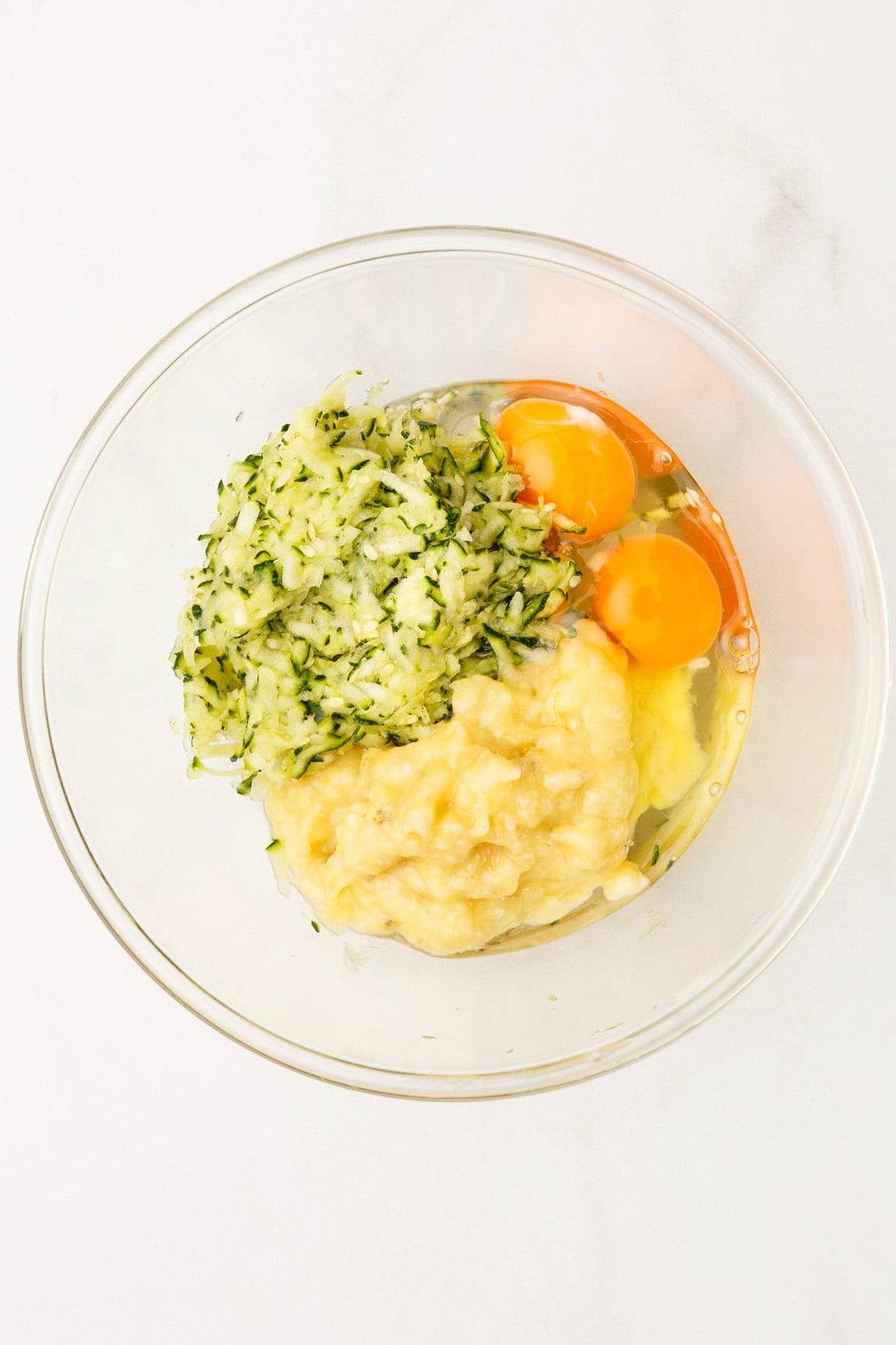 adding the zucchini with the banana and egg. 