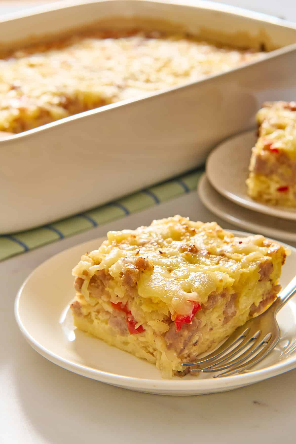 Slice of Bisquick breakfast casserole on a white plate.