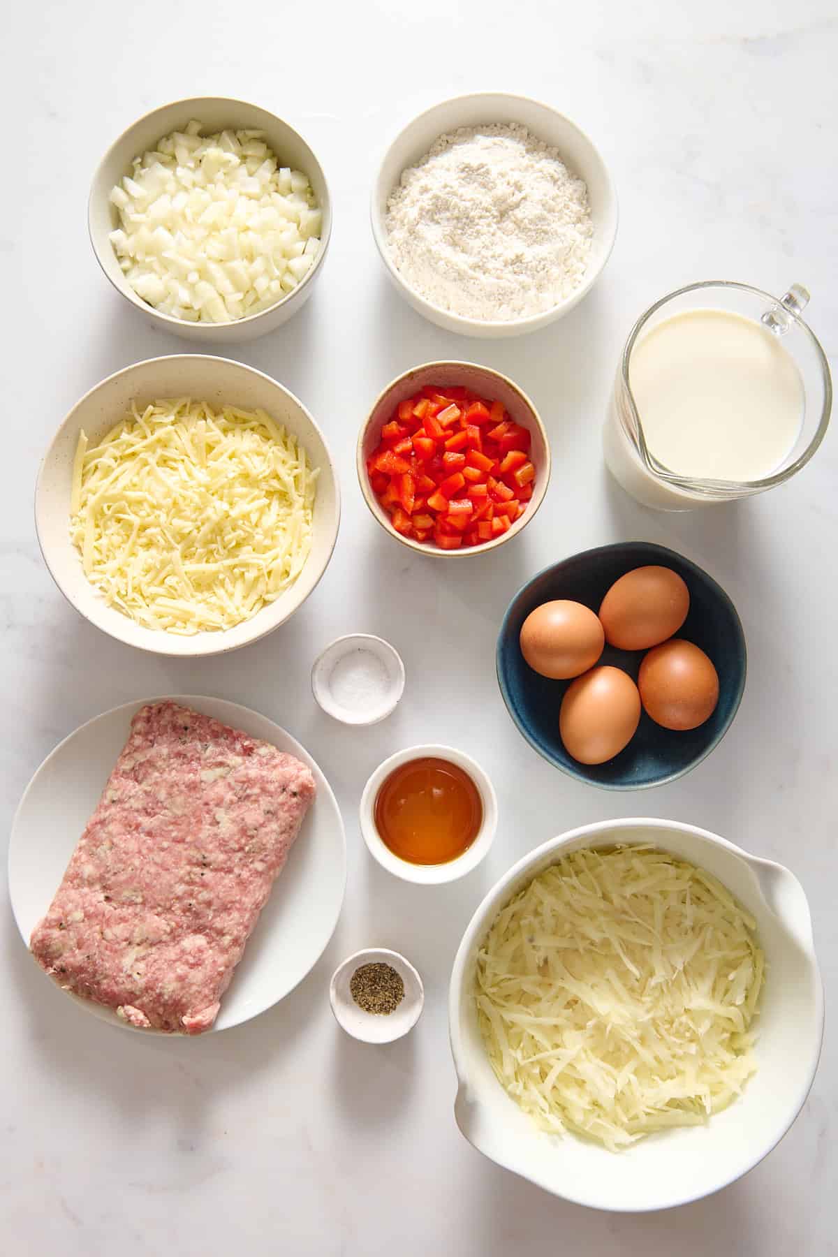 Ingredients for Bisquick Breakfast Casserole in separate bowls.
