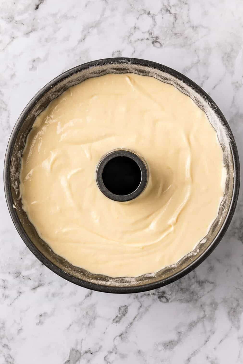 pouring the cake batter into the bundt pan. 