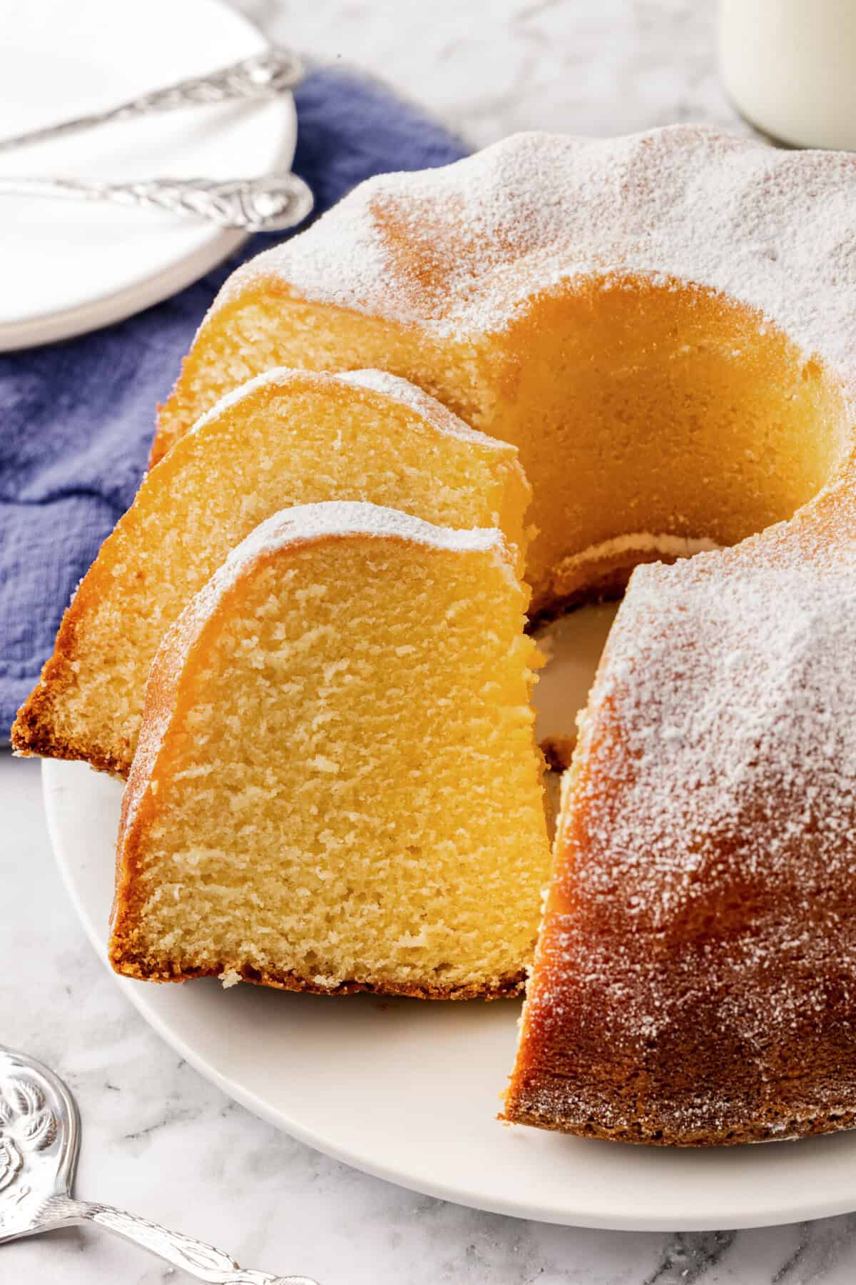 sliced buttermilk pound cake on a white serving plate. 