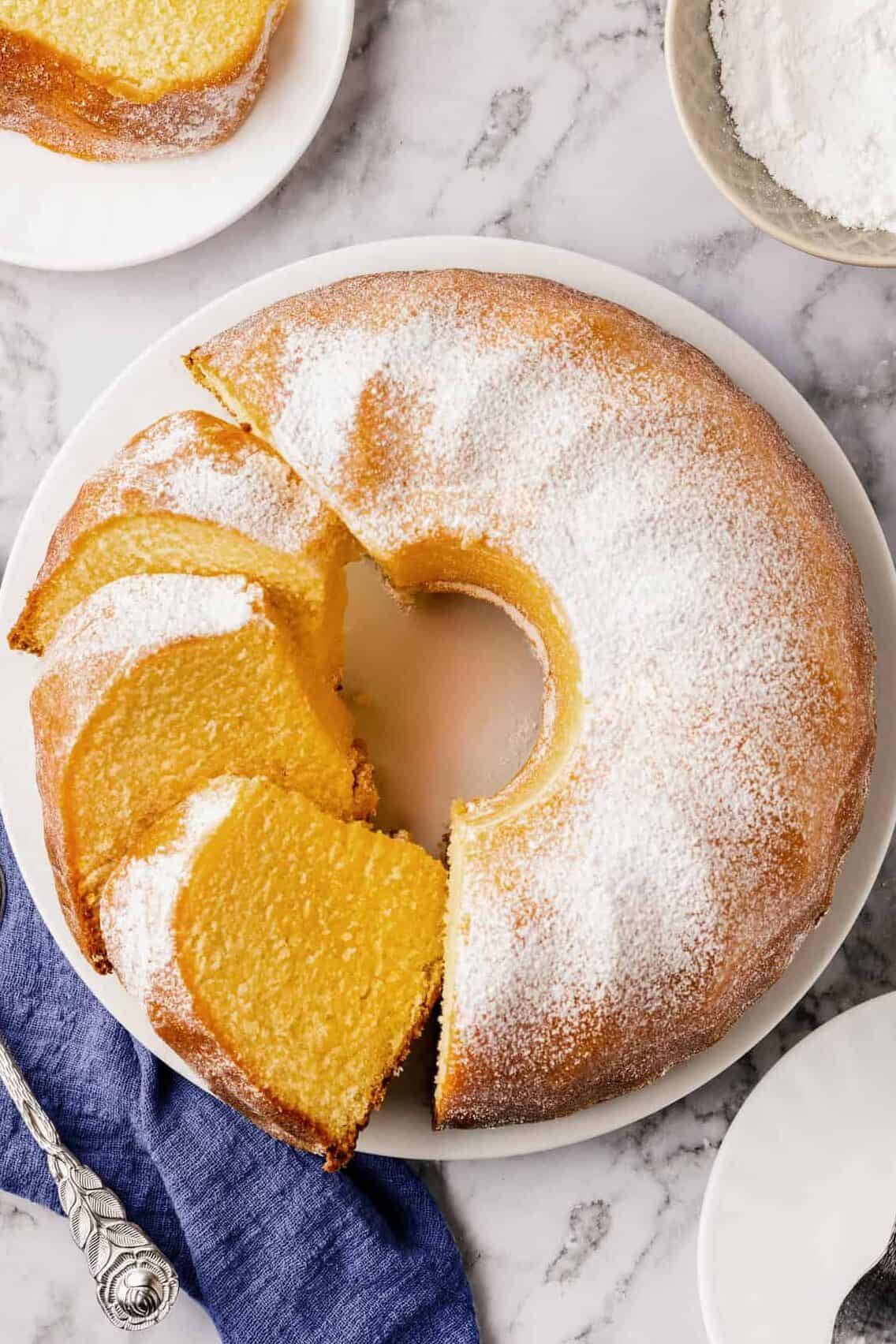 top down image of buttermilk pound cake served on a white round plate.