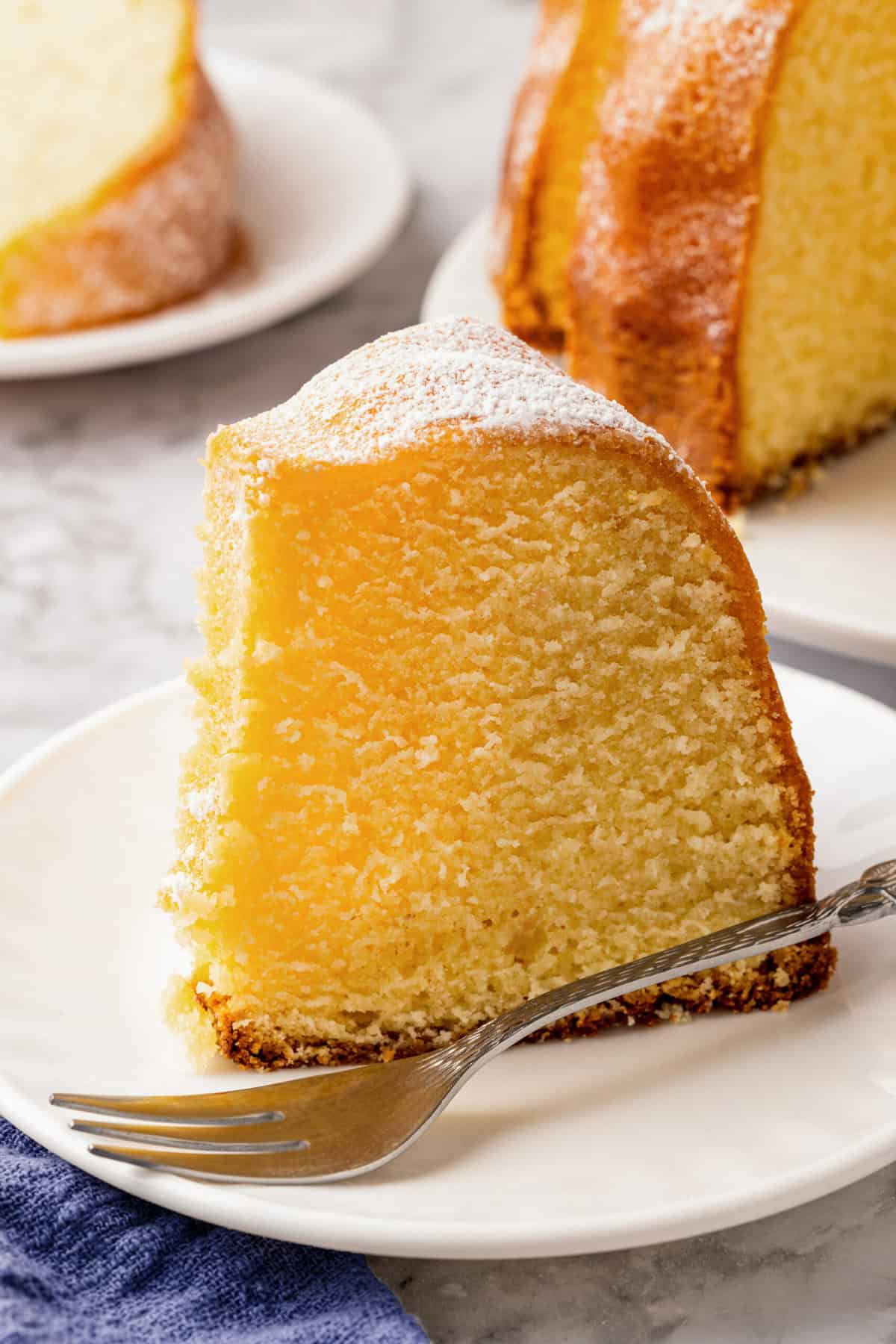 slice of buttermilk pound cake served on a white round plate. 