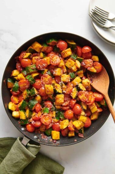 A skillet of diced zucchini and tomatoes.