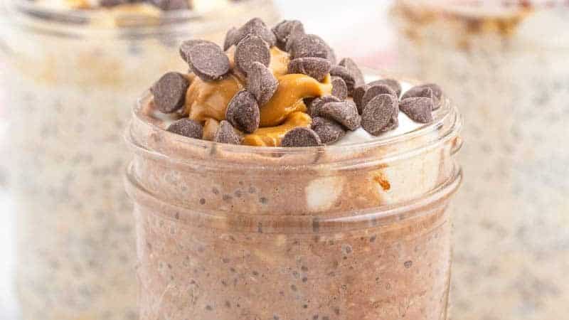 overnight oats with chia seeds in mason jar topped with peanut butter and chocolate chips