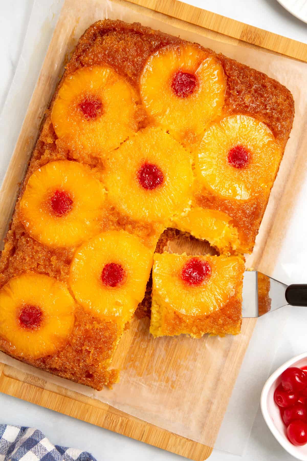 Pineapple upside down cake being served with a spatula. 