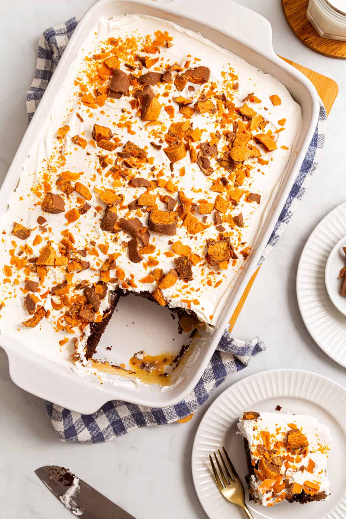 Top-down image of Butterfinger poke cake in a casserole baking dish.