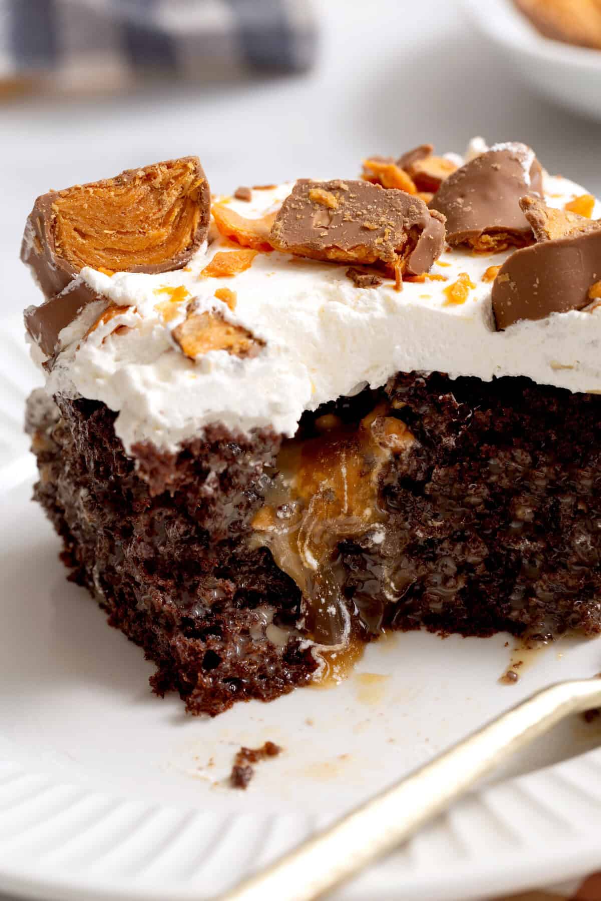 Close-up image of a square slice of butter, finger poke cake showing the cross-section.