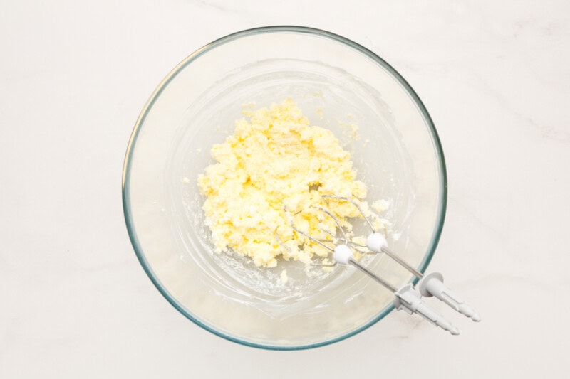 Cream cheese and instant pudding mix in a bowl.