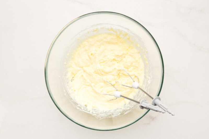A bowl of cream cheese, vanilla pudding mix, and sweetened condensed milk beaten until fluffy.