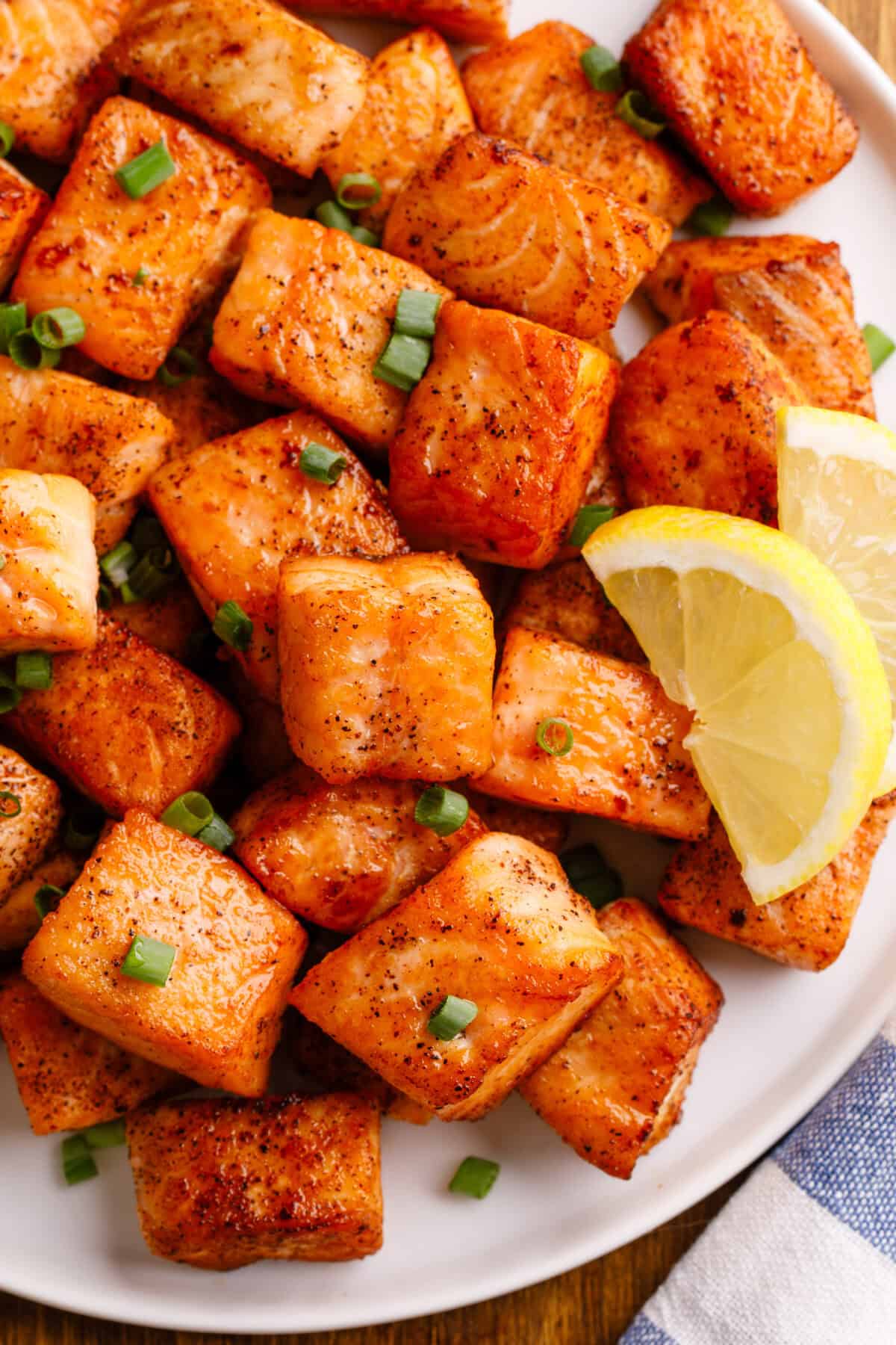 Pan-fried salmon bites on a plate.