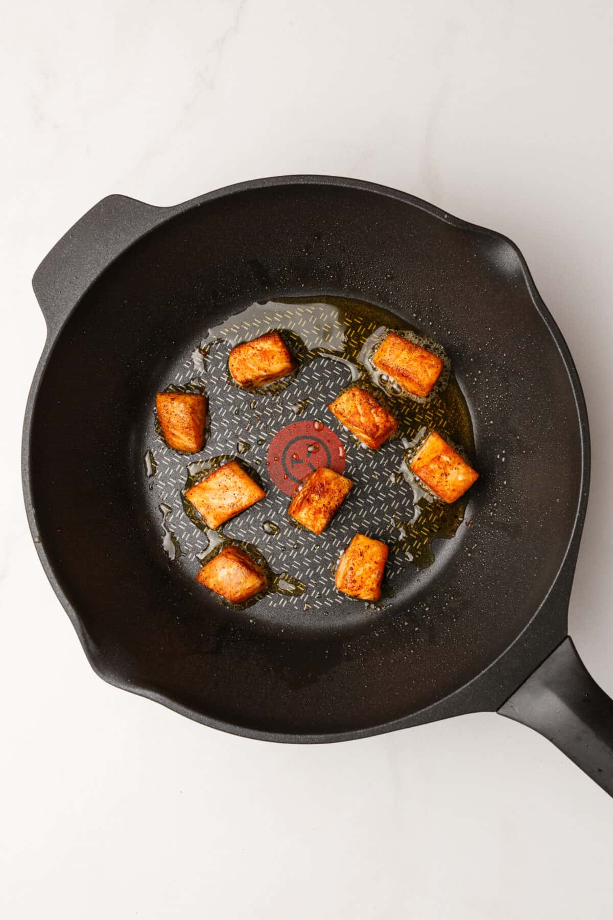 Cooked salmon bites in skillet