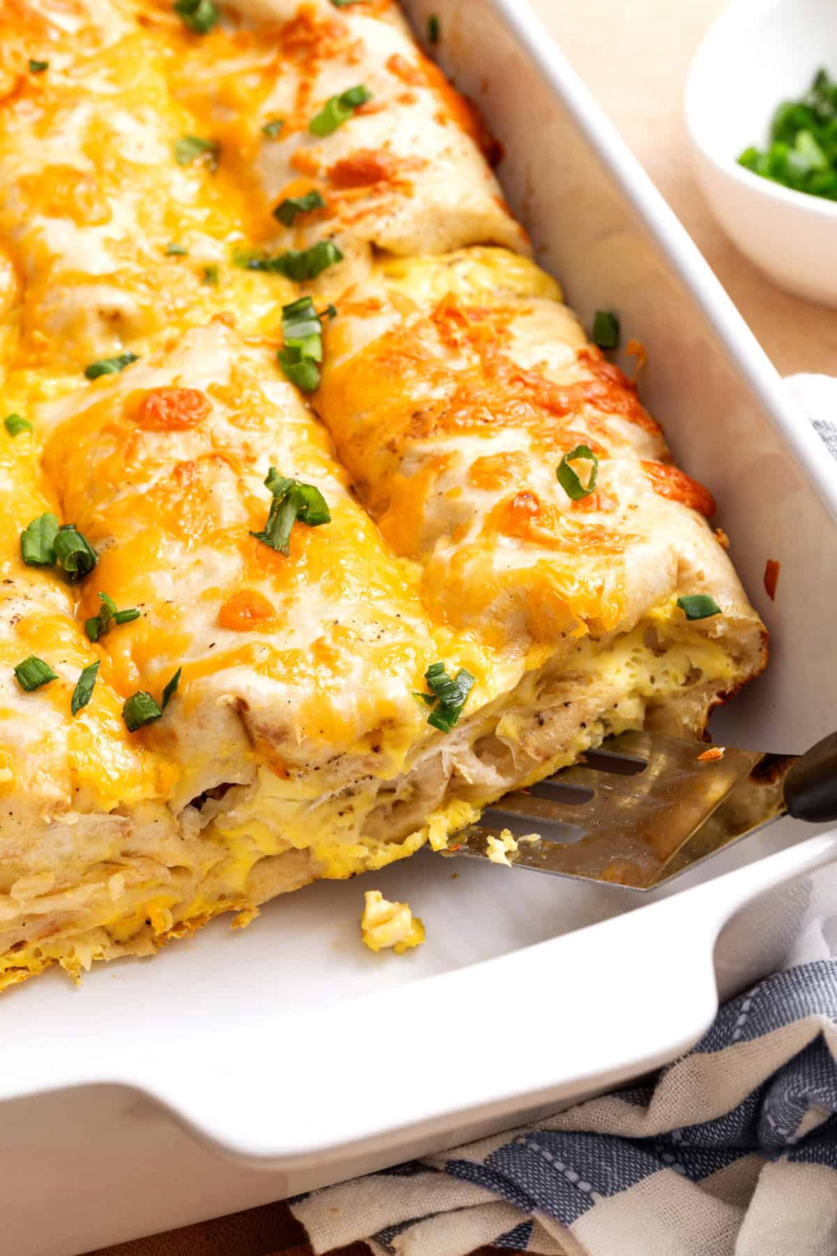 breakfast burrito casserole in a white dish