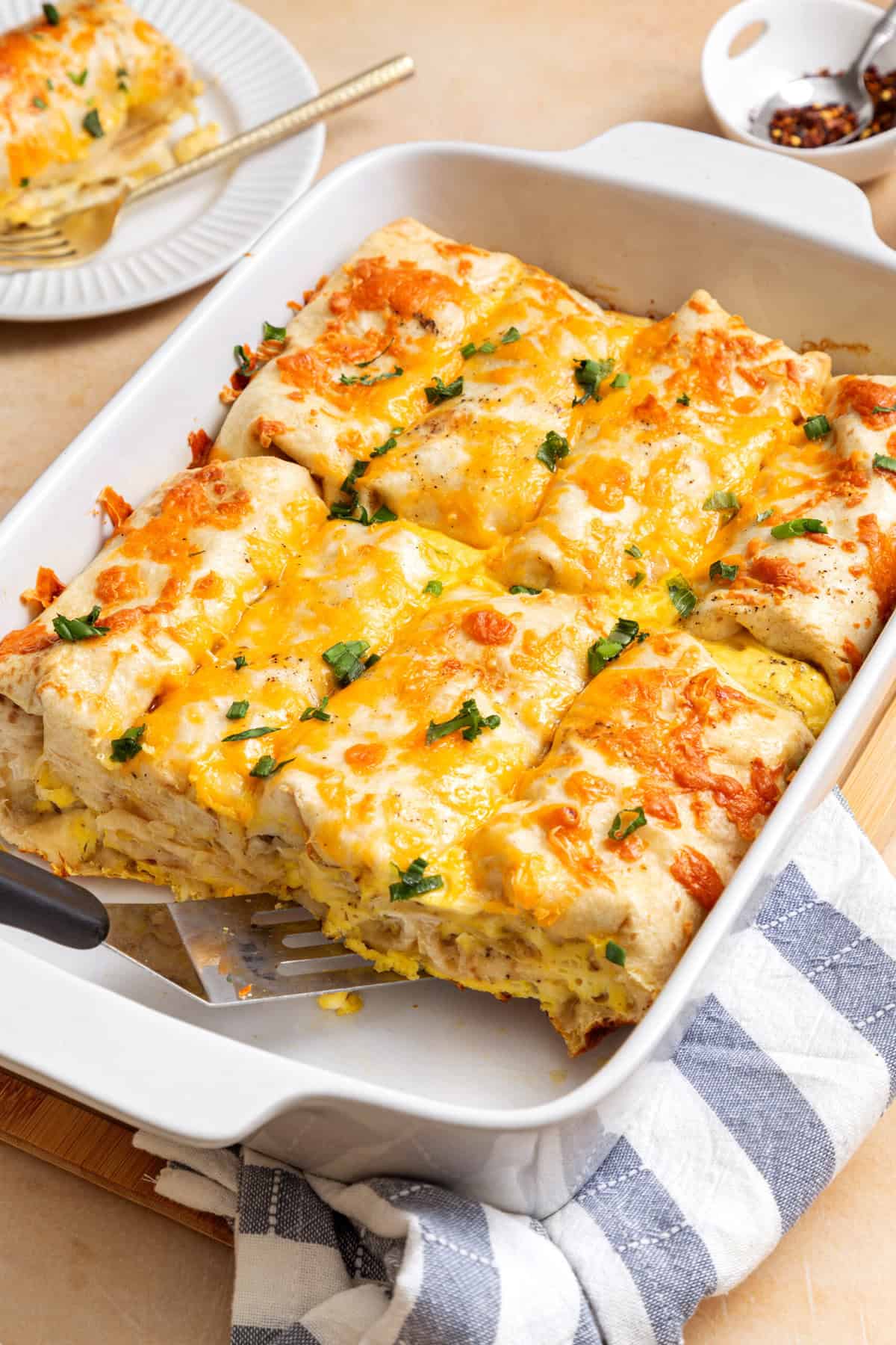 breakfast burrito casserole with kitchen towel