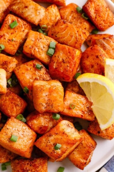 Pan-fried salmon bites on a plate.