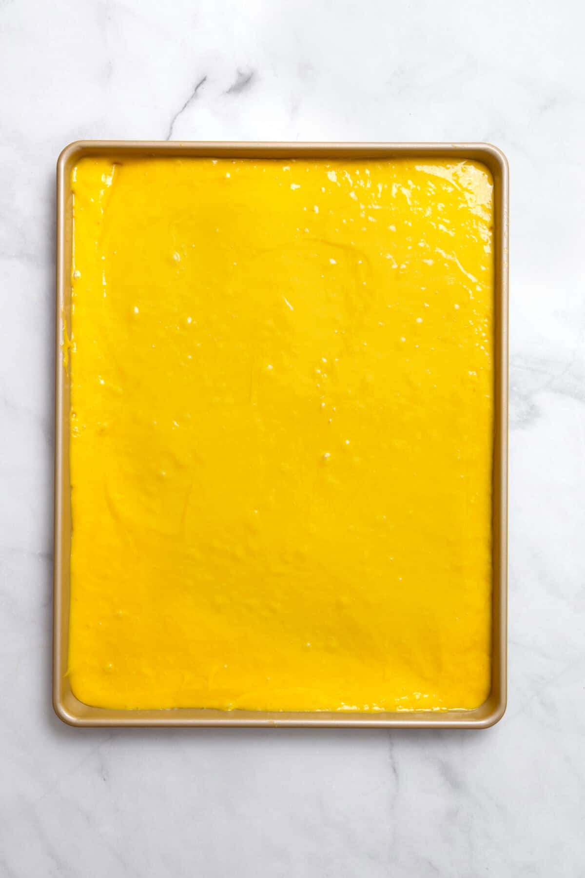 lemon cake batter in sheet pan