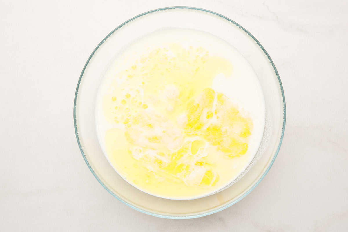 Wet ingredients for Cracker Barrel pancakes in a glass bowl.