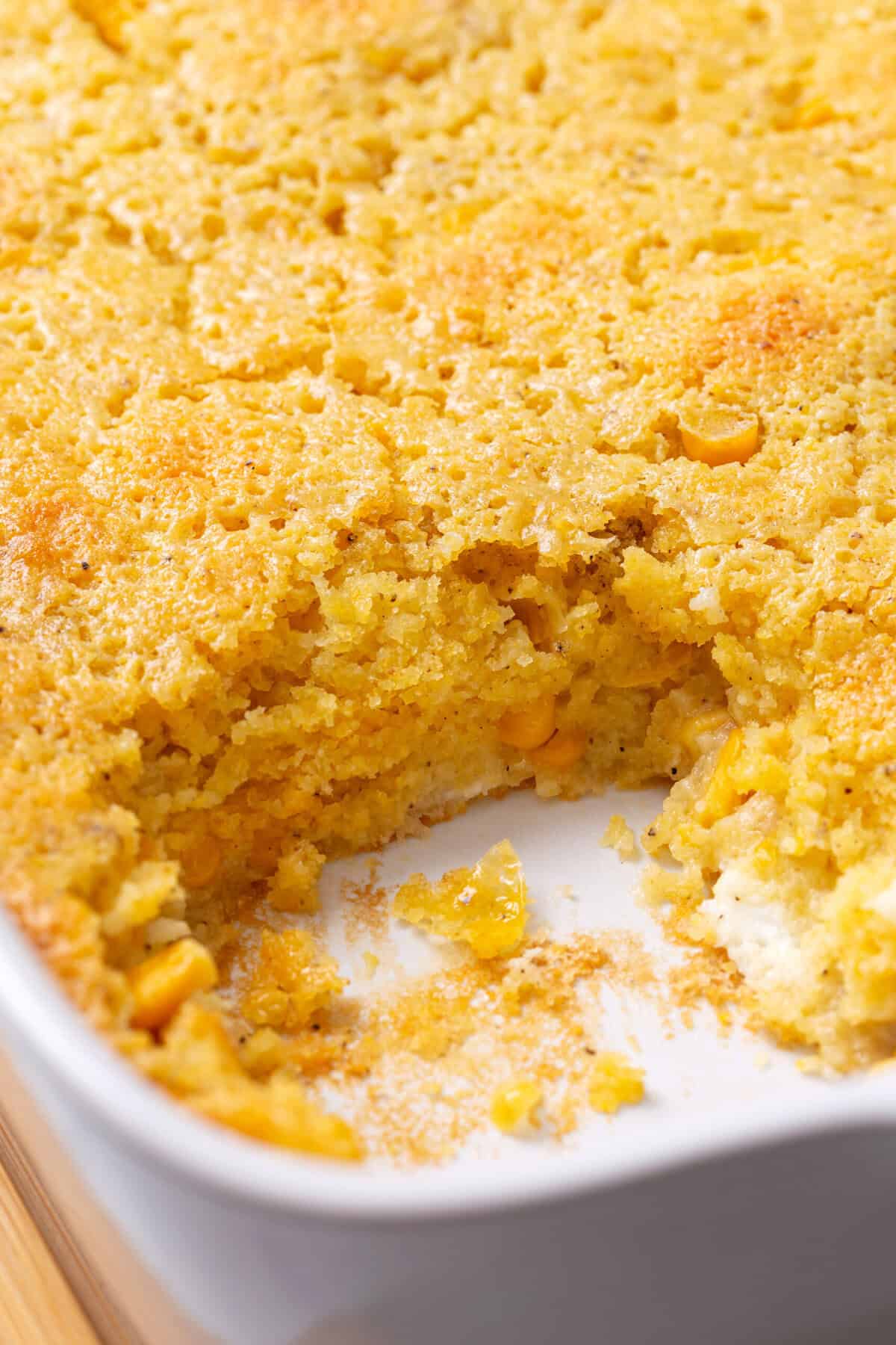 Golden-brown corn soufflé in a baking dish showing its fluffy and creamy texture