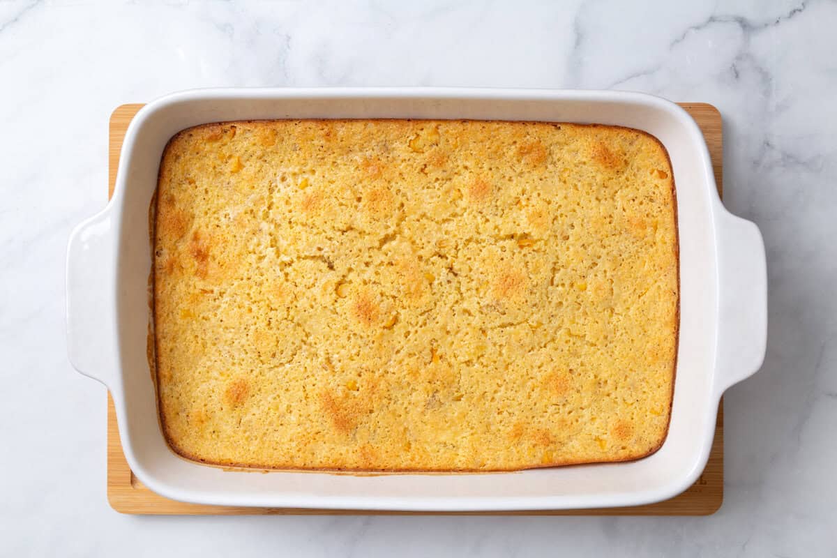 corn souffle in a white casserole dish aerial view. 
