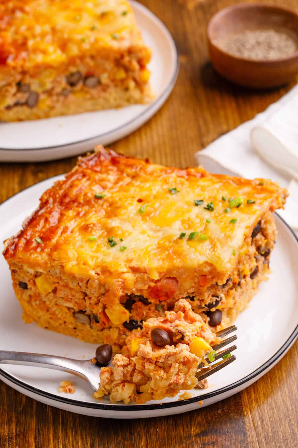 Mexican Breakfast Casserole Mexican Breakfast Casserole on a plate with a some casserole on a fork.