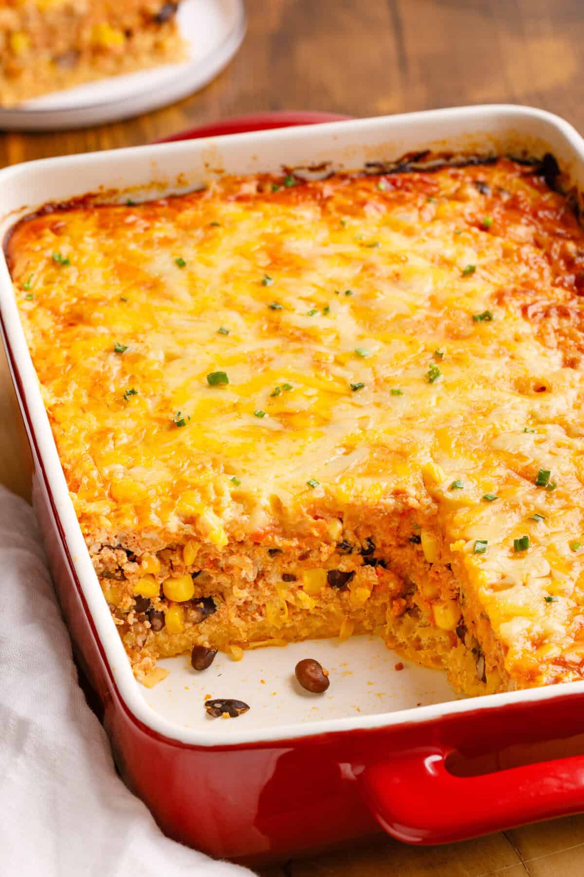 Mexican Breakfast Casserole Mexican Breakfast Casserole in a baking dish with a serving taken out.