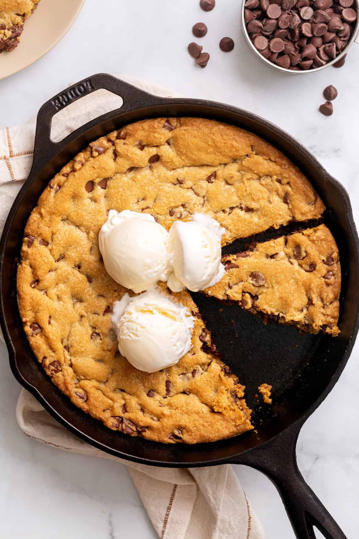 Chocolate chip cookie made in a cast iron skillet topped with vanilla ice cream. 