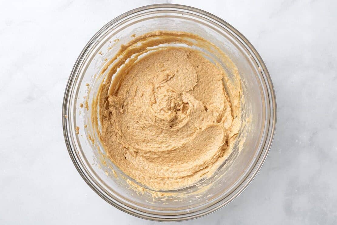Creamed butter and sugar in a glass bowl.