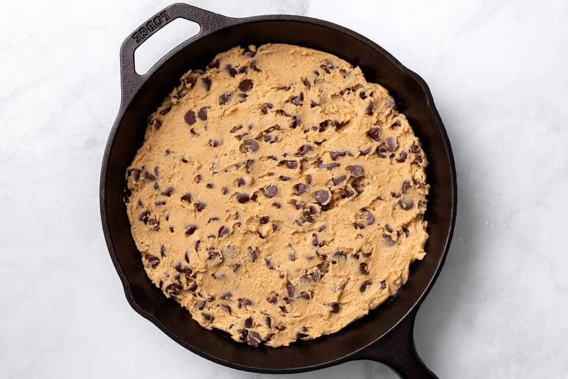 cookie dough in a cast iron skillet.