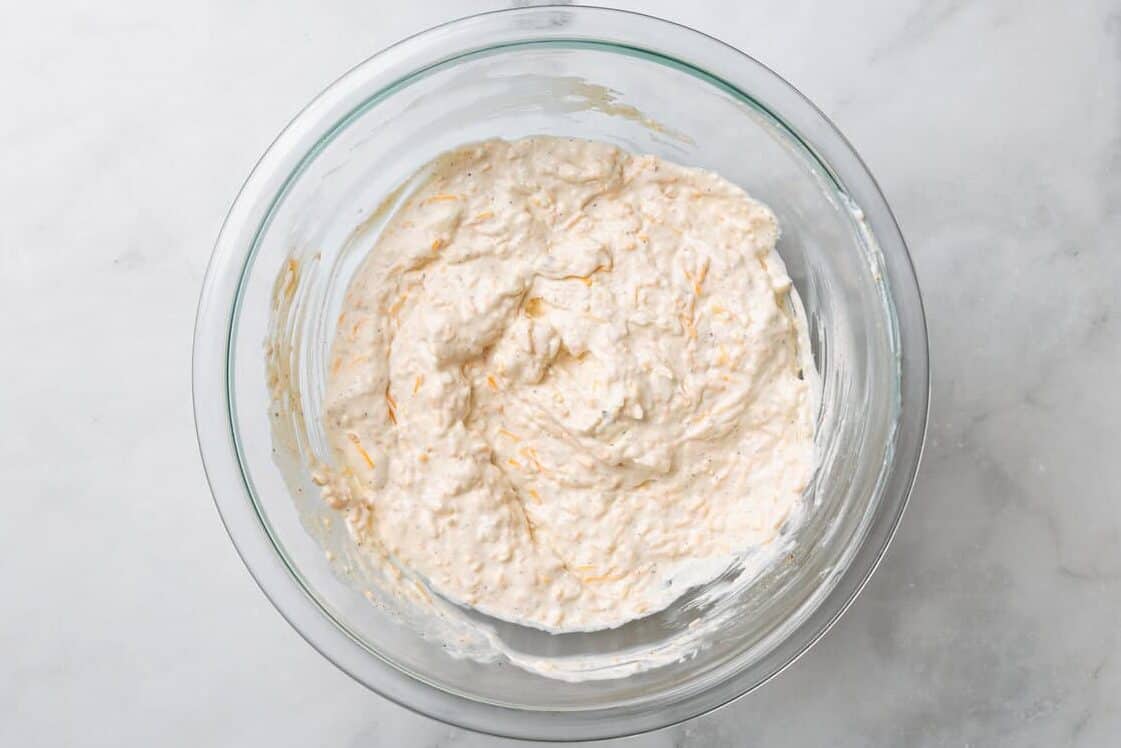 Mixing the ingredients for hot crab dip. 