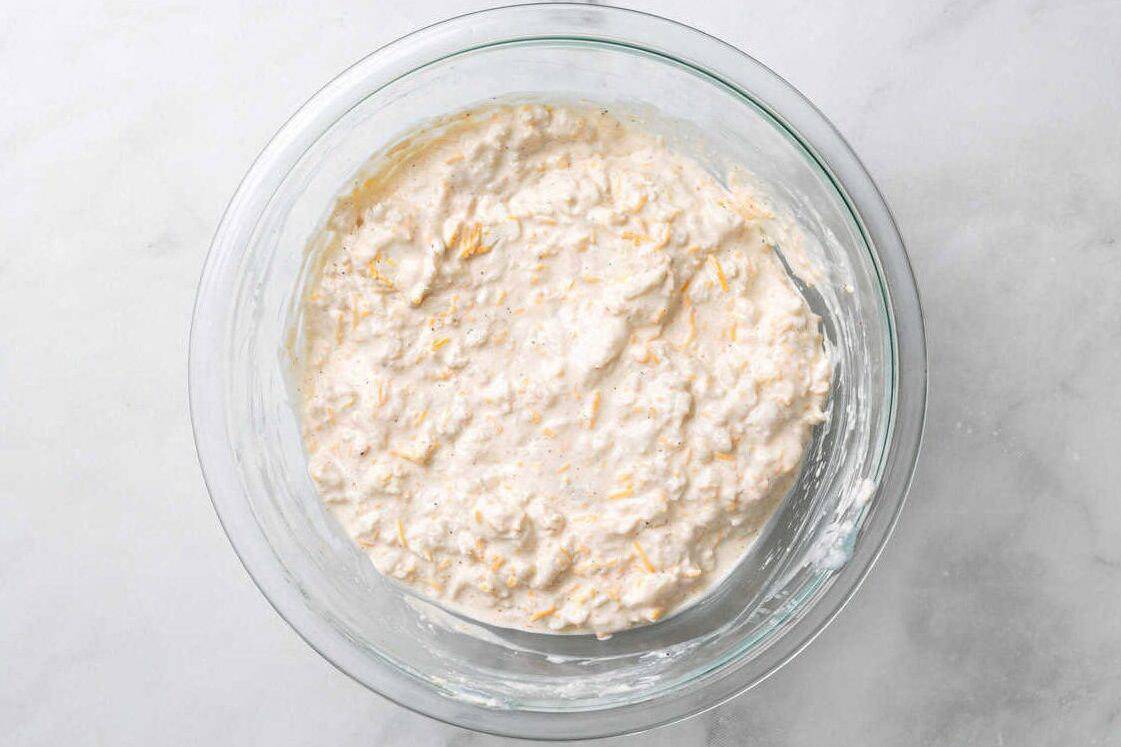 Putting the crab in the mixture for hot crab dip. 