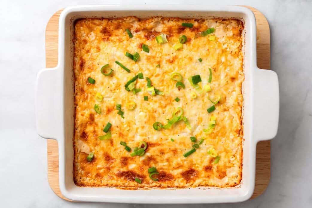 Hot crab dish baked, freshly out of the oven in a white baking dish. 