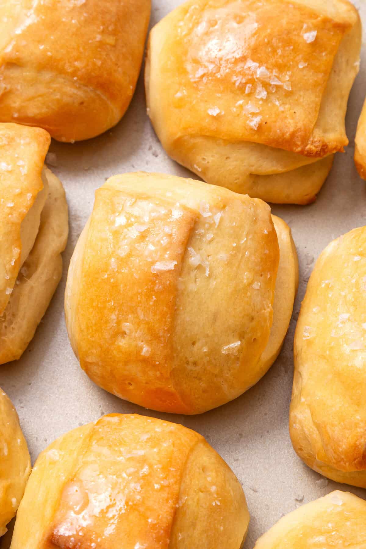Parker house rolls on parchment paper. 