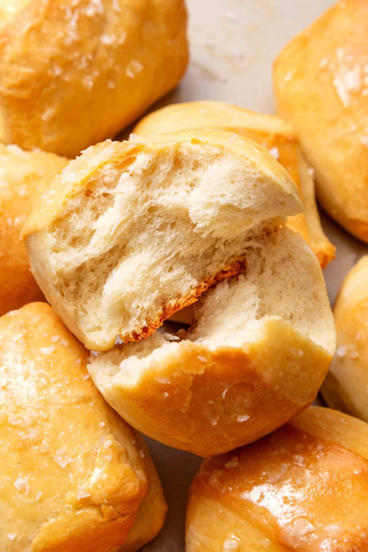 close up image of parker house rolls with the cross section showing. 