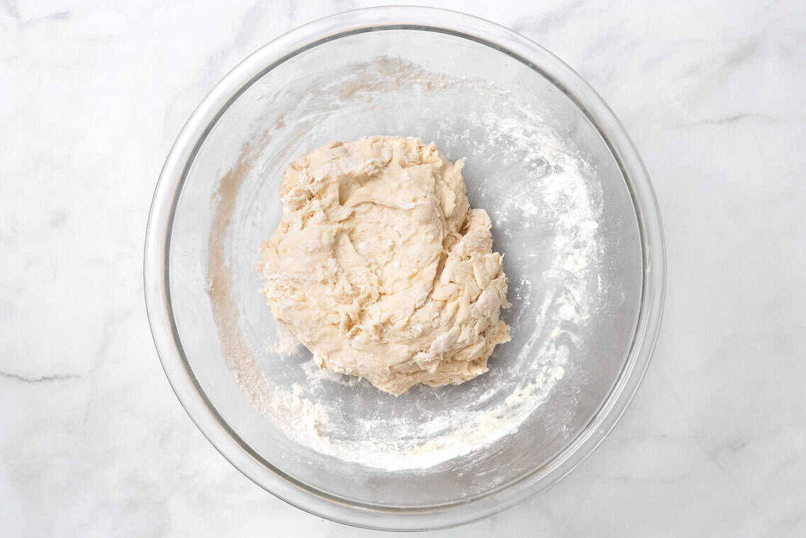roll dough in a clear bowl with flour. 