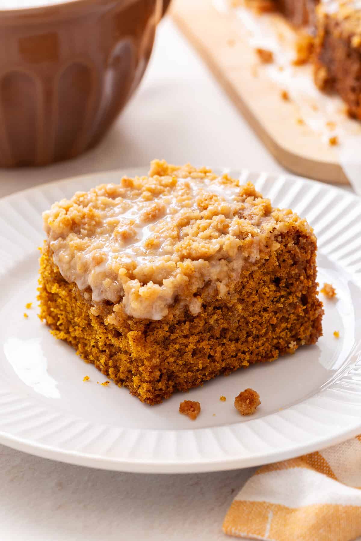 Slice of pumpkin coffee cake on a white plate.