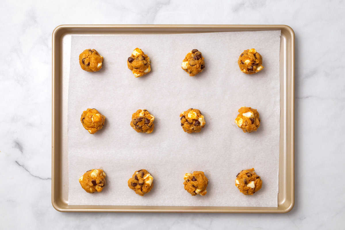 pumpkin cookie dough scooped on a tray pumpkin s'more cookie dough scooped on a tray.