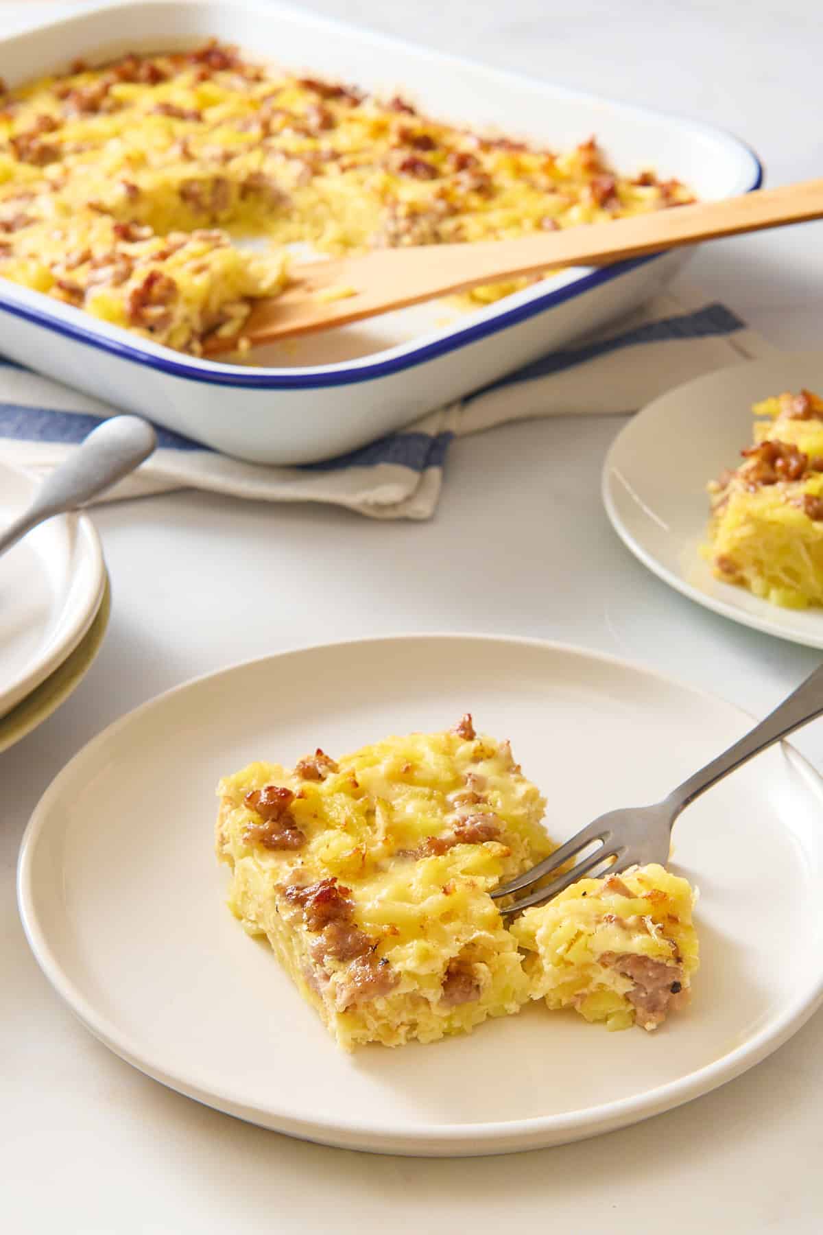Hashbrown egg casserole on plate with fork.