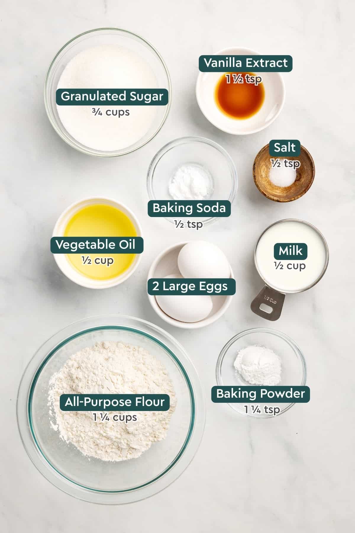Ingredients for homemade cake mix, including sugar, vanilla, baking soda, salt, oil, eggs, milk, baking powder, flour.
