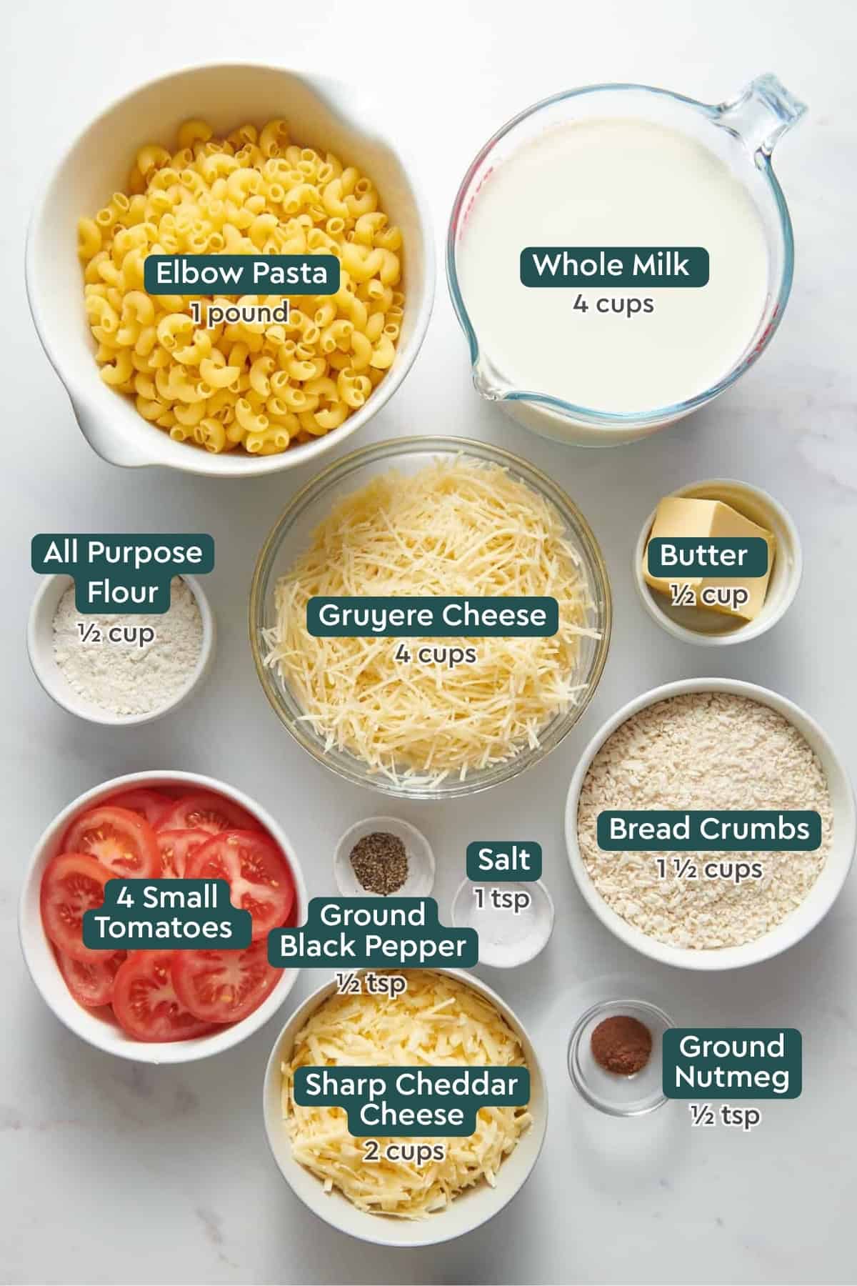 All of the ingredients for Ina Garten Mac and Cheese in bowls on a white countertop.