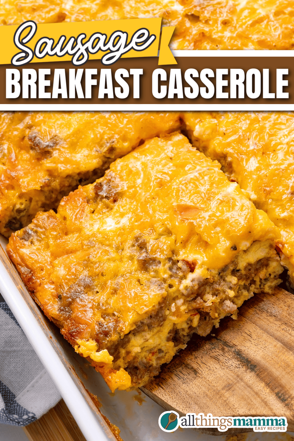 A close-up of a cheesy, golden-brown sausage breakfast casserole with eggs, sausage, and peppers in a baking dish.