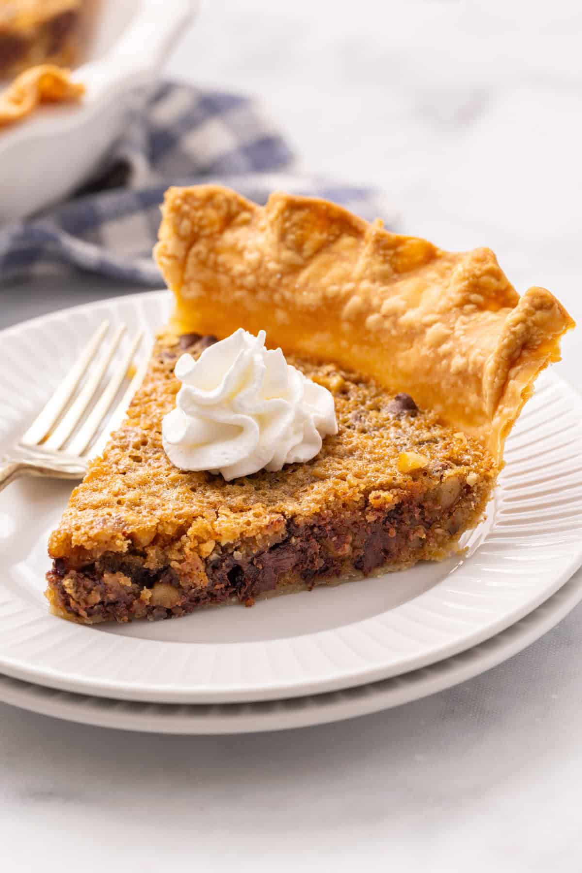slice of kentucky derby pie with whipped cream.