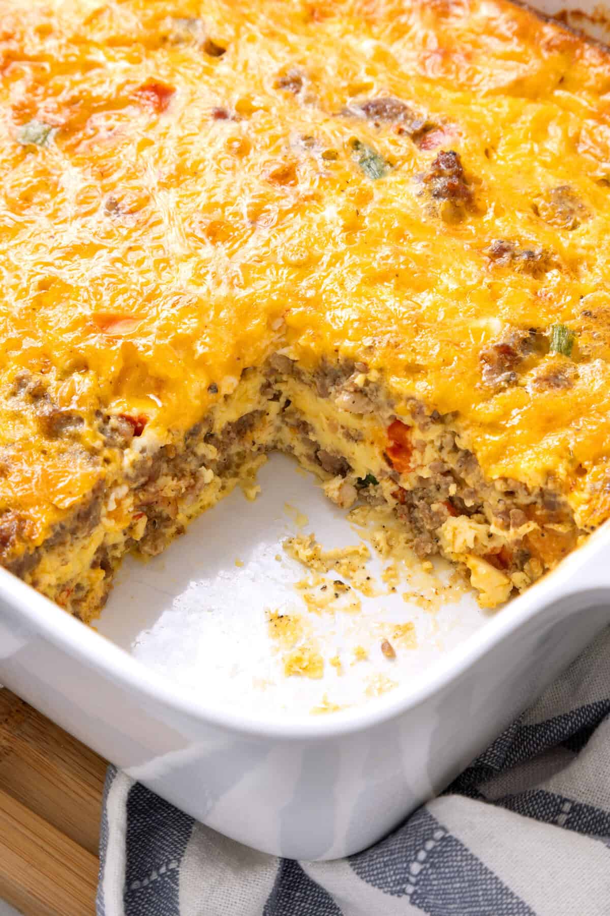 Sausage Breakfast Casserole in a baking dish with a serving taken out. 