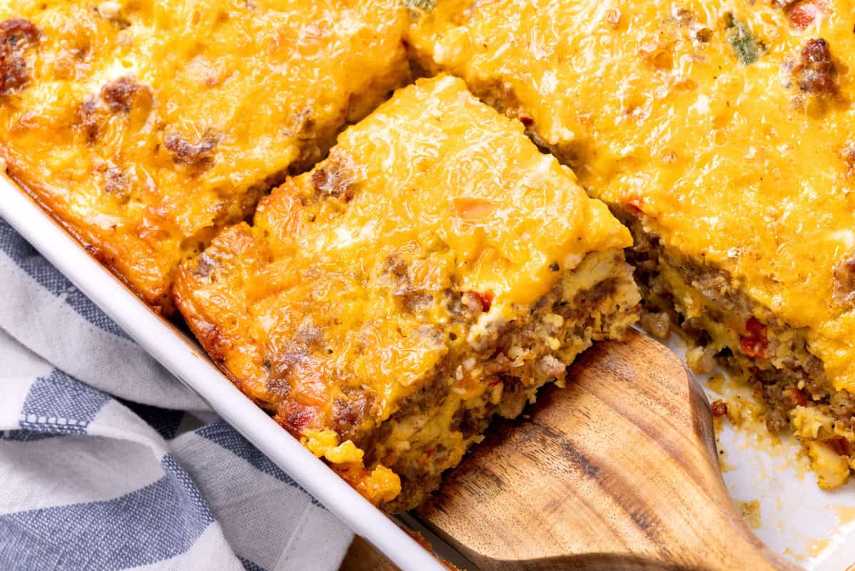 Cutting a sliced Sausage Breakfast Casserole. 