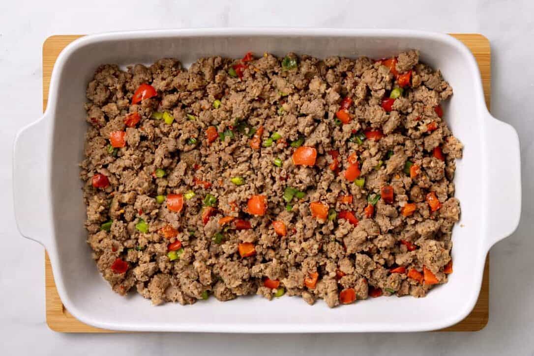 Sausage and peppers in a baking dish. 