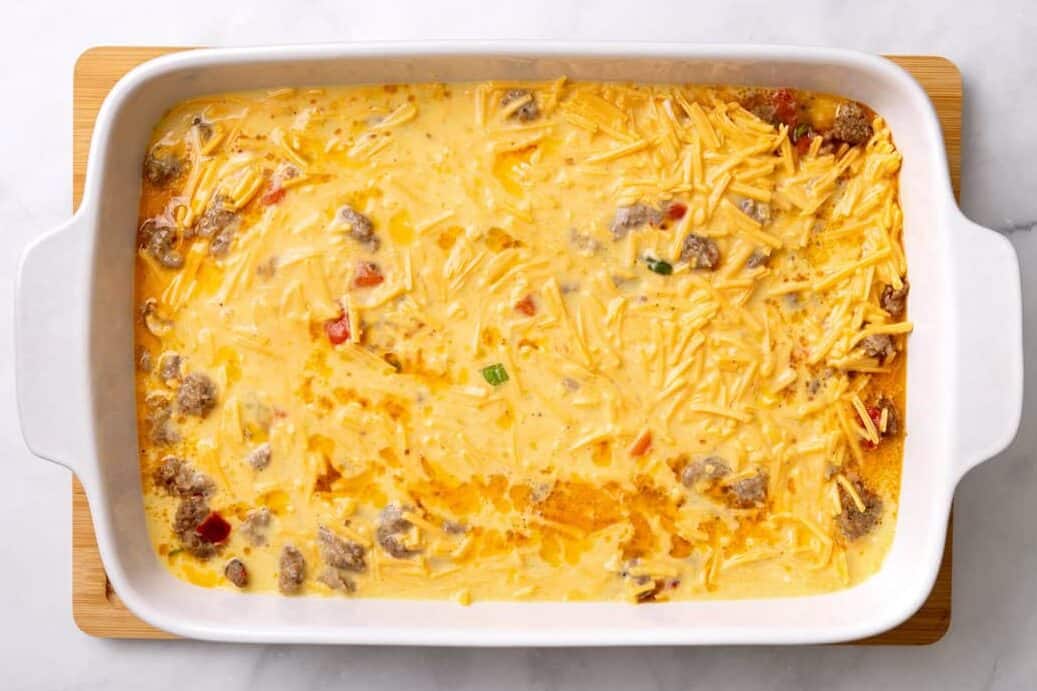 The ingredients for Sausage Breakfast Casserole being prepped in a baking dish. 