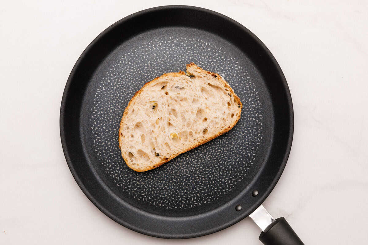 A slice of bread in a non stick pan. 
